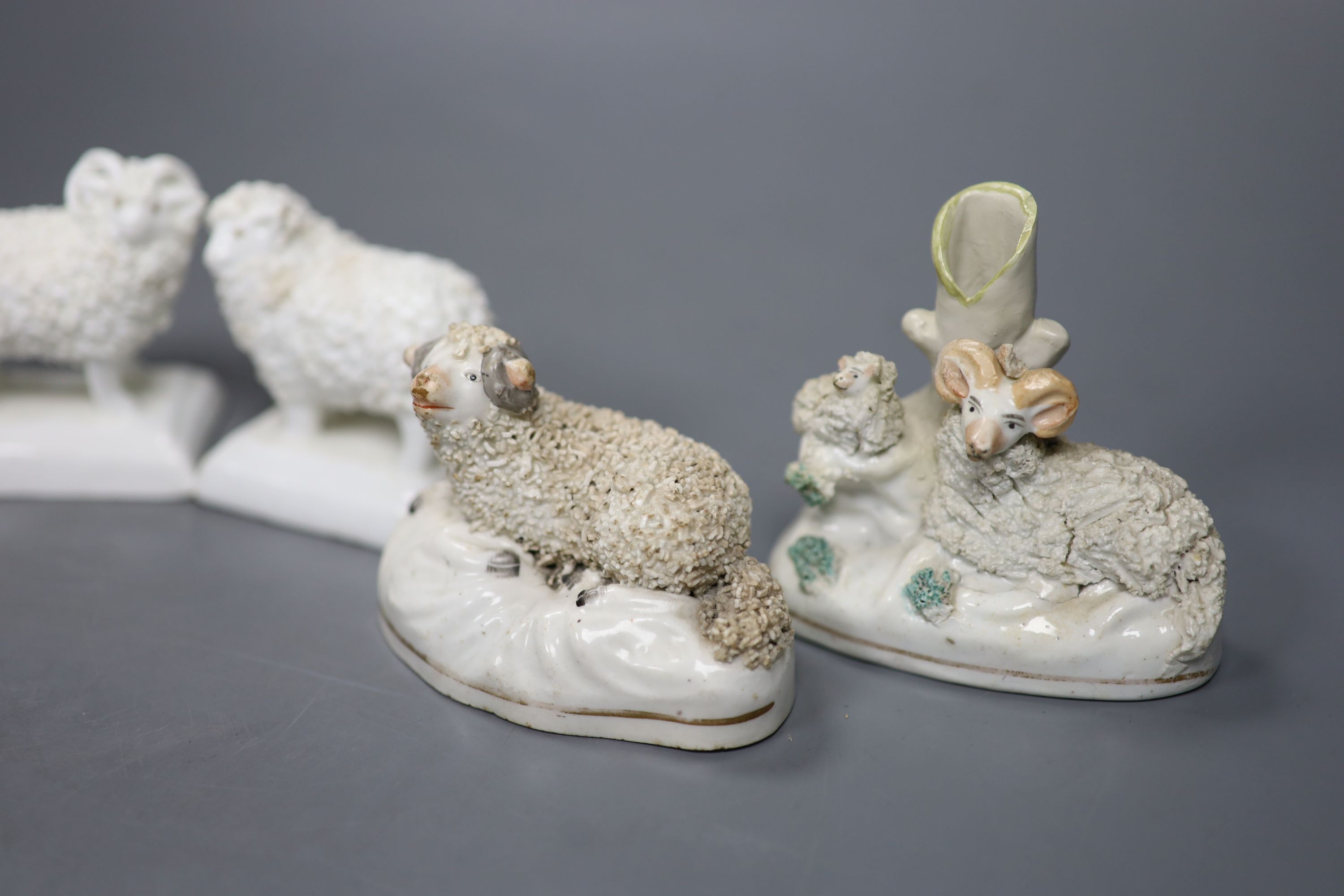 Two pairs of Staffordshire porcelain figures of sheep and two similar ‘sheep’ spill vases, c.1830-50, tallest 8.5 cm